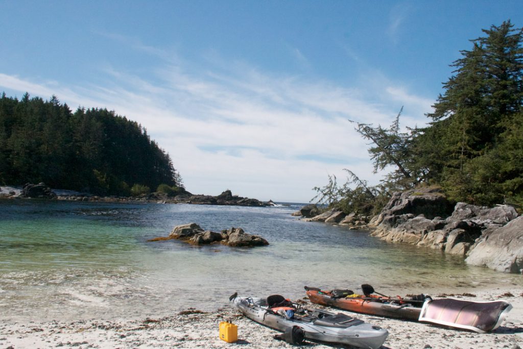Sandy cove with two motorized fishing kayaks with Helix MD motor drives