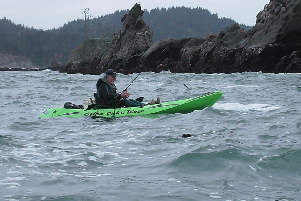 man fishing in green cobra kayaks fishing kayak