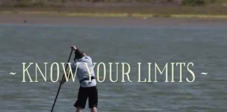 man paddling on a lake with the words know your limits across the photo