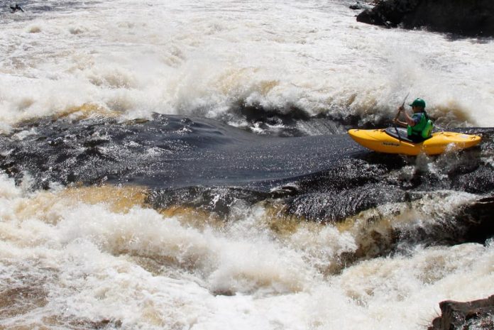 Kayaker Graham Kent going through whitewater in Liquidlogic Kayak's Delta V 88 whitewater kayak