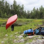 Canoeist carries canoe on a portage in Temagami