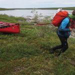 7 Steps To Plan Your Dream Canoe Trip Frank Wolf towing his canoe behind him on a portage