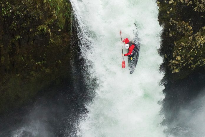 a kayaker hucking off a waterfall, one of many kayaking slang terms