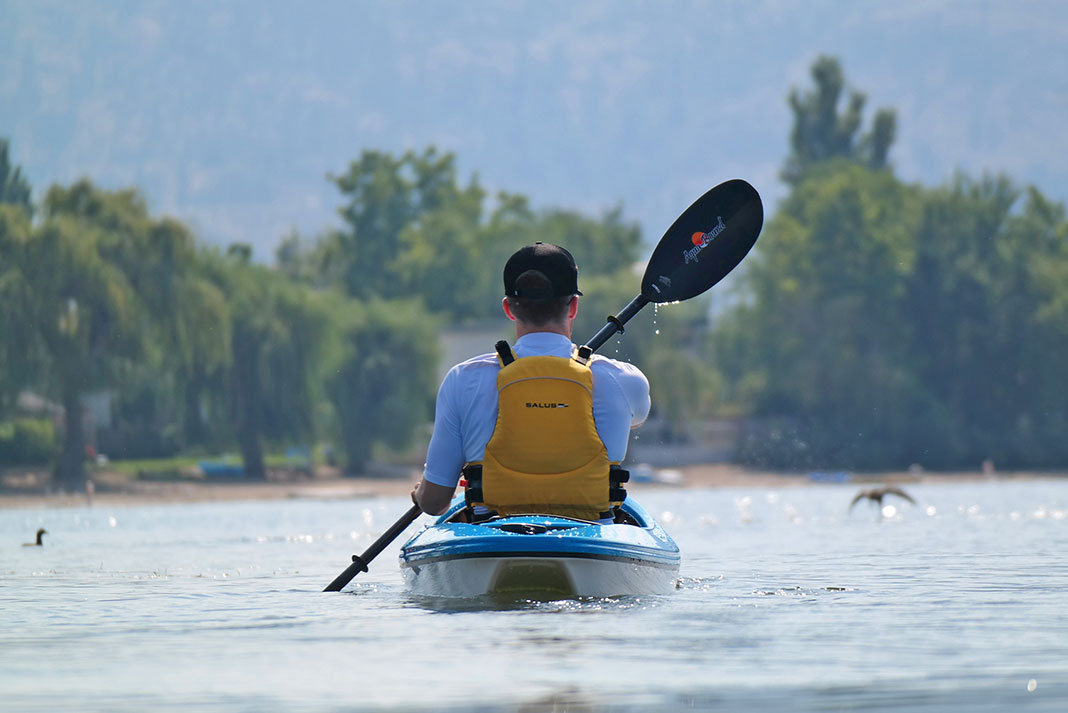 man paddles in a Delta Kayak wearing a Salus PFD, one of the best life jackets for kayaking