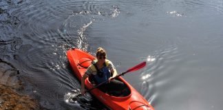 Woman paddling a Delta 12 AR recreational kayak