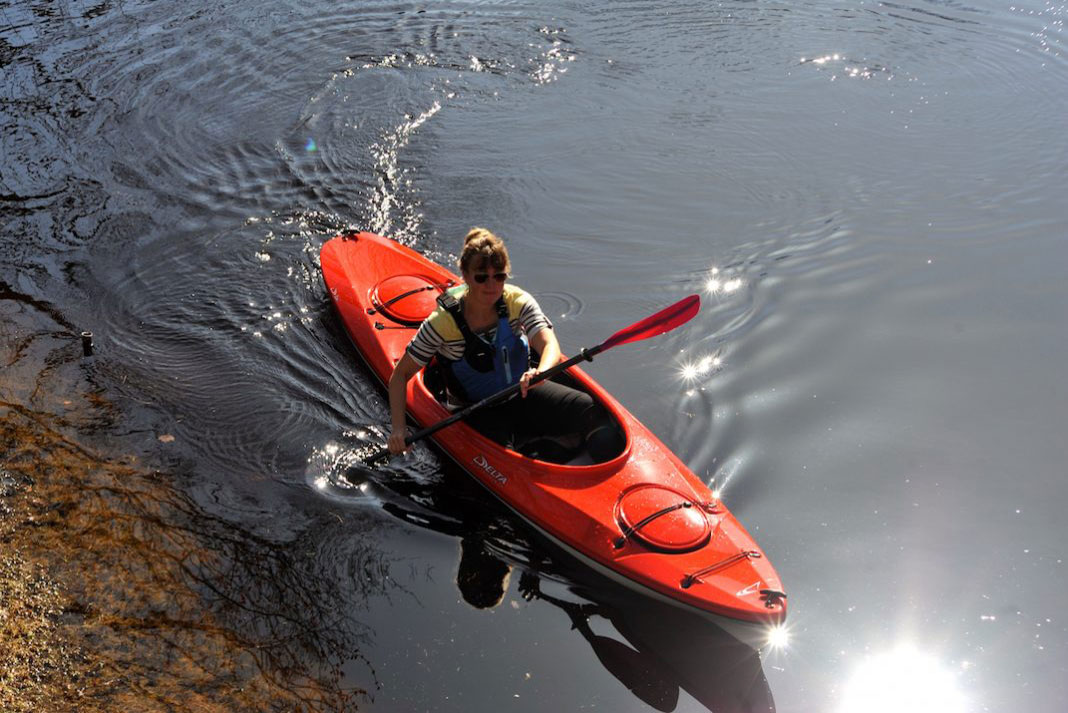 Woman paddling a Delta 12 AR recreational kayak