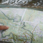 5 Steps To Plan An Epic Whitewater Kayak Expedition Pointing at a map while planning a kayak expedition