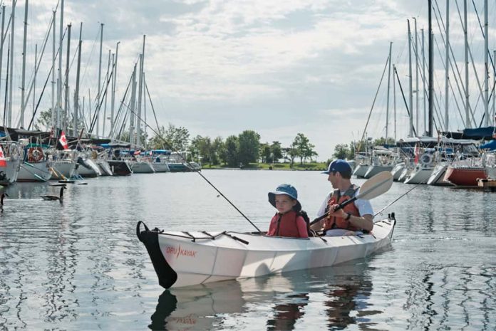 father and son fishing from a tandem Oru Haven