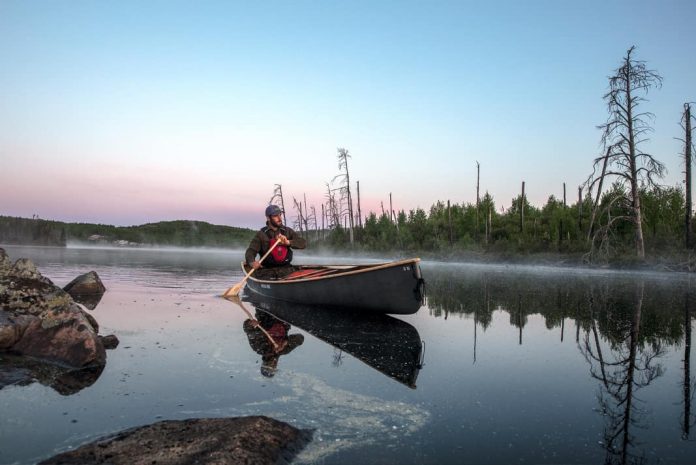 composite canoe on foggy lake