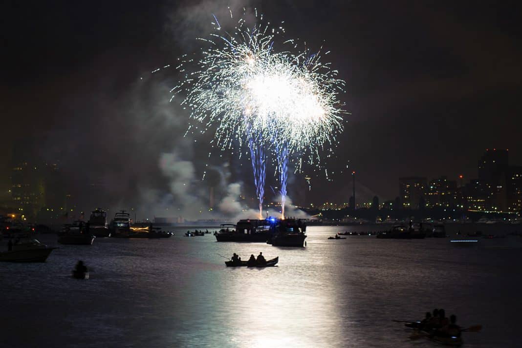 Kayakers and boaters enjoy the Fourth of July fireworks display on the the Boston Harbor.