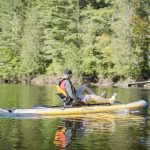 Hobie Mirage i11S Inflatable Kayak-Paddleboard Hybrid Review Man paddles a Hobie Mirage i11S inflatable kayak/paddleboard hybrid