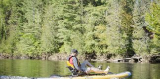 Man paddles a Hobie Mirage i11S inflatable kayak/paddleboard hybrid