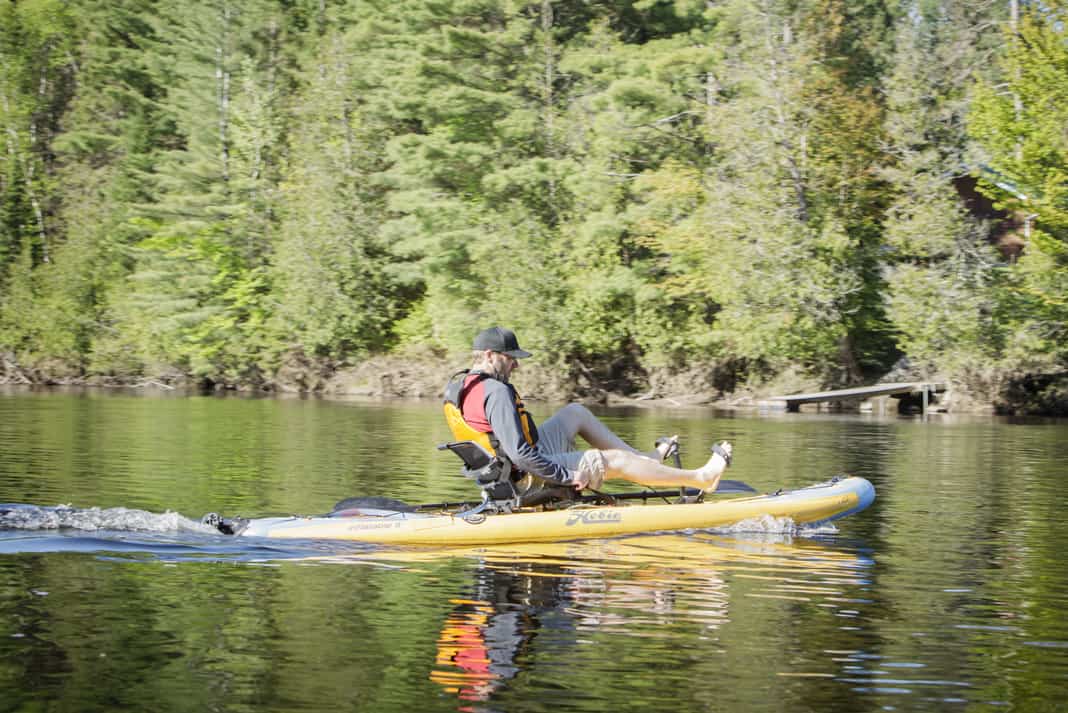 Man paddles a Hobie Mirage i11S inflatable kayak/paddleboard hybrid