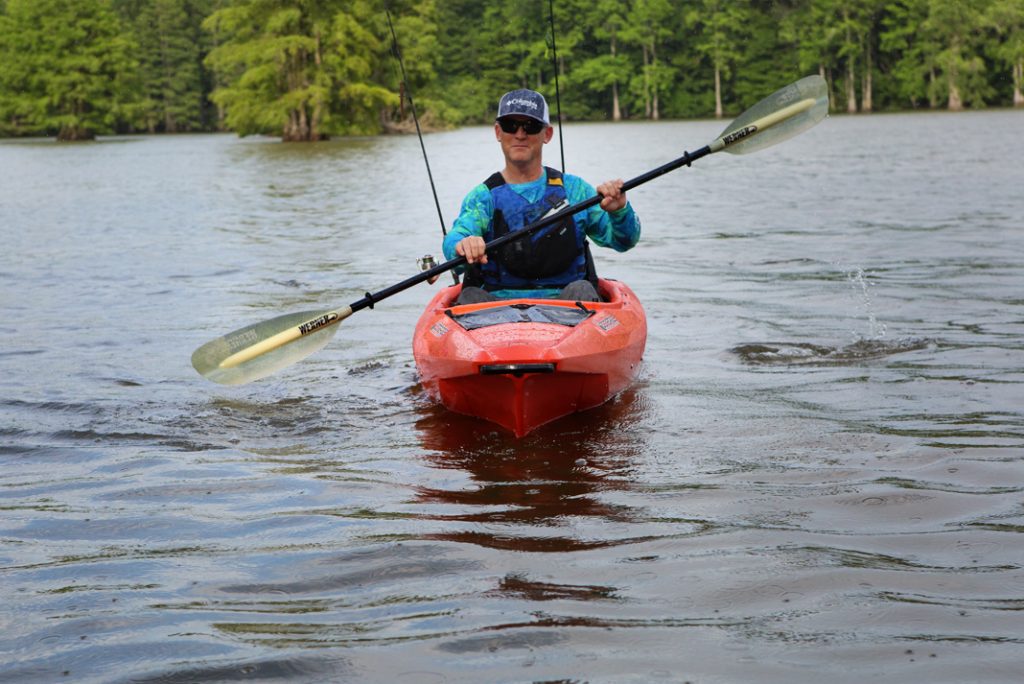 man paddles a Bonafide EX123 expedition fishing kayak