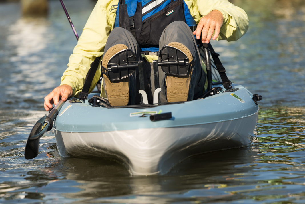 person pedals a Hobie Mirage Passport 10.5 fishing kayak