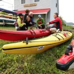 Kayak Buying Guide: How To Find The Right Boat For You People sitting on grass beside kayaks