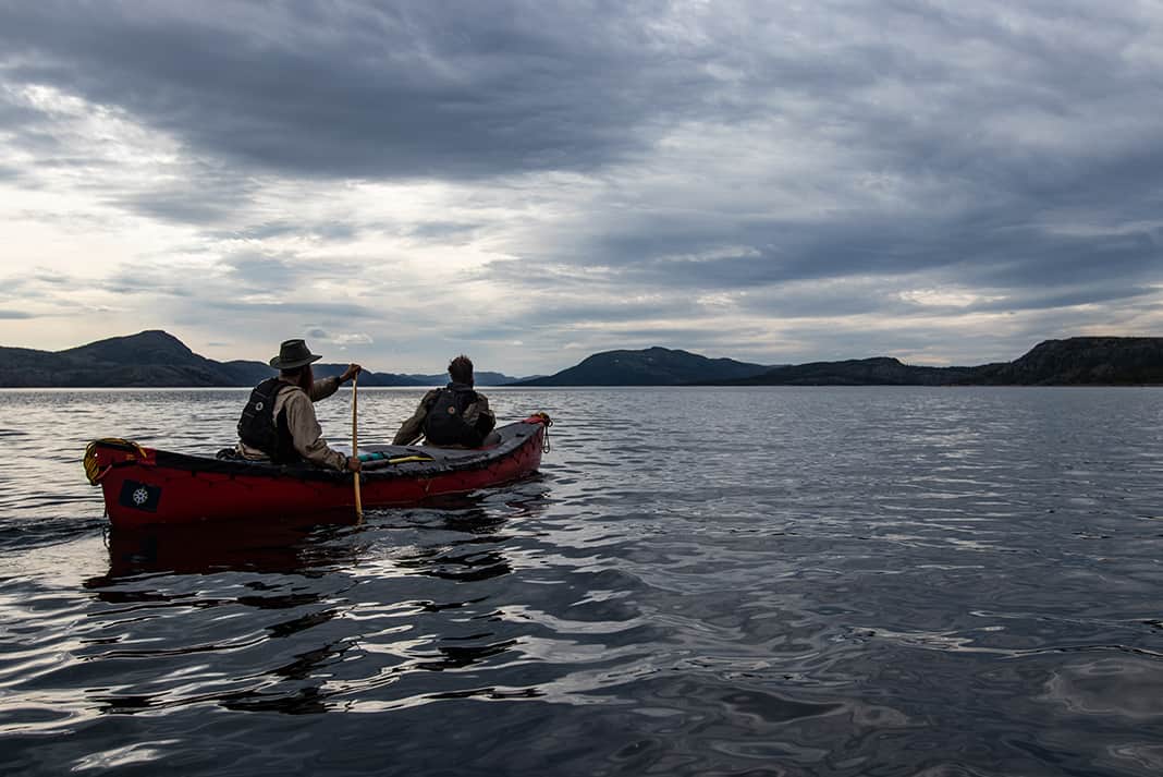 Two canoeists paddling on the ocean in Labrador