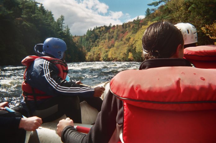 View from behind people in a raft on a river