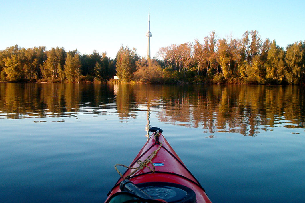 Front of a kayak pointing at the CN Tower