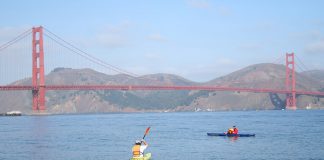 Two kayakers in front of the Golden Gate Bridge
