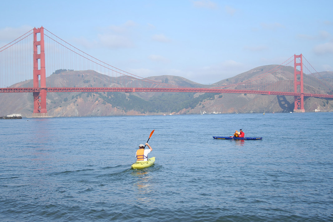 Two kayakers in front of the Golden Gate Bridge