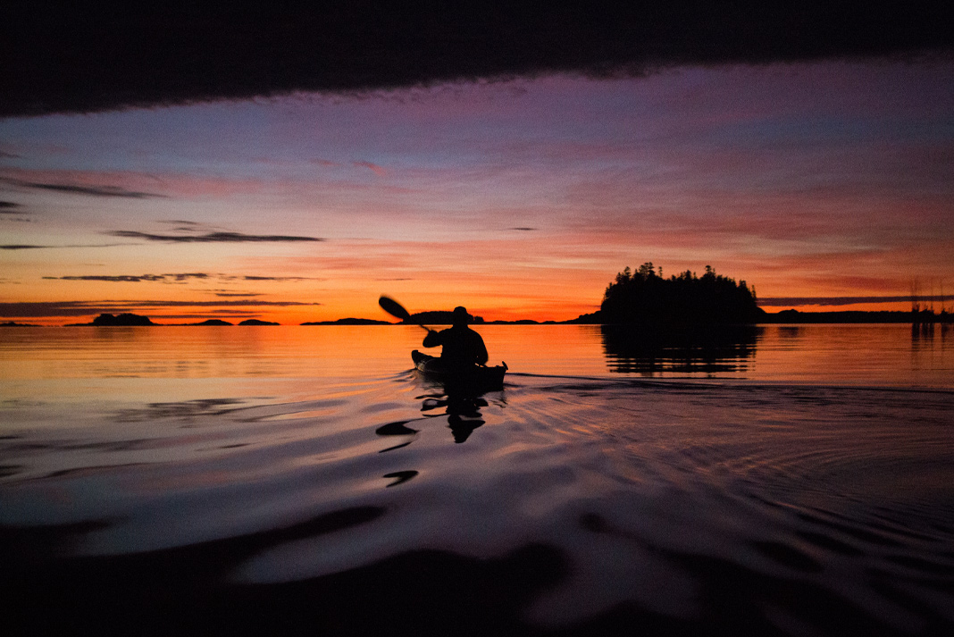 kayaker paddling at sunset