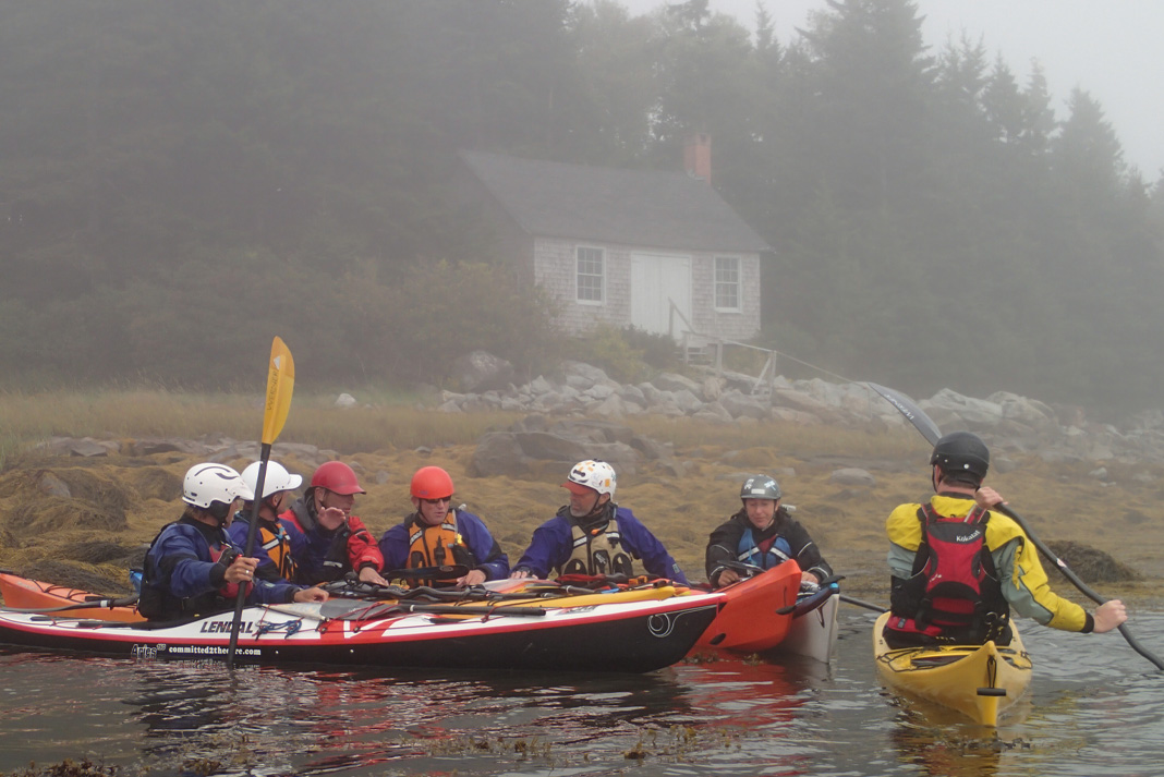 Sea kayakers gathered in a group on the water