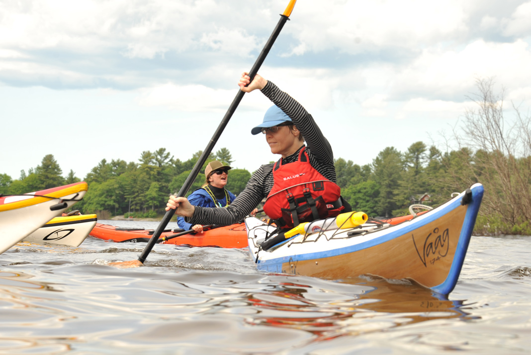 Two women practicing sea kayaking skills.