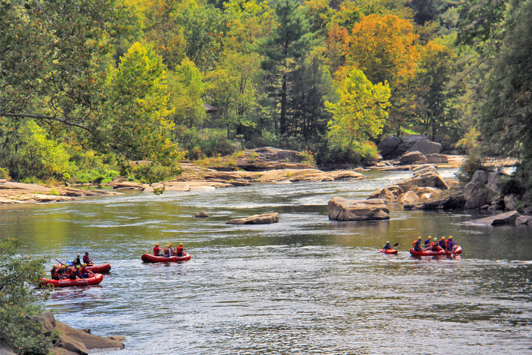 Red rafts floating down a river
