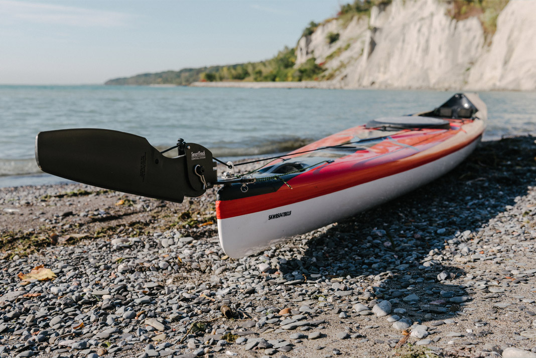 Kayak with rudder sitting on beach