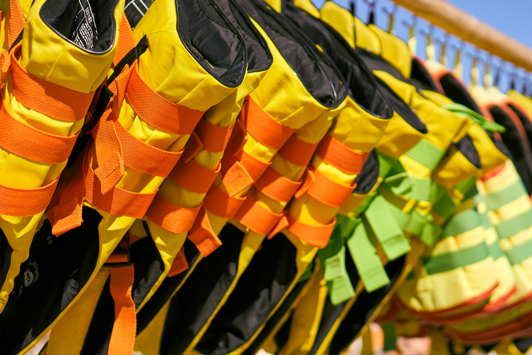 Life jackets hanging on a rack