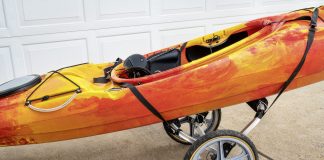 An orange and yellow kayak on a cart.