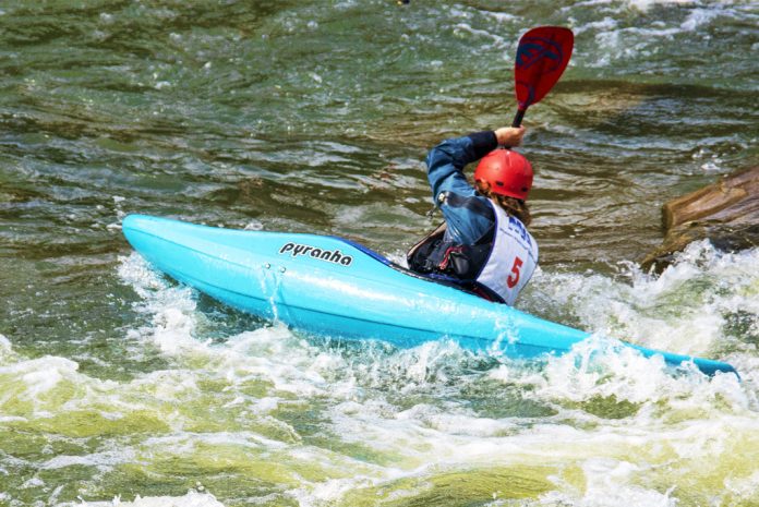 Person in a blue whitewater kayak