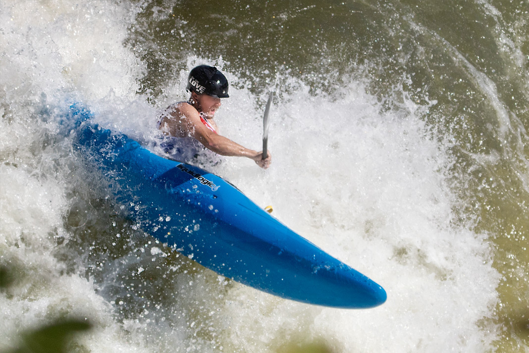 Person in blue whitewater kayak