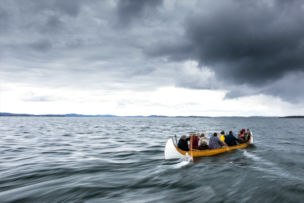 People paddling voyageur canoe