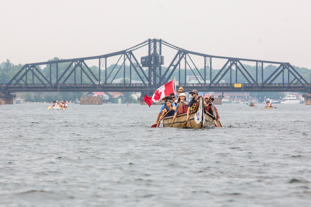 People paddling voyageur canoe