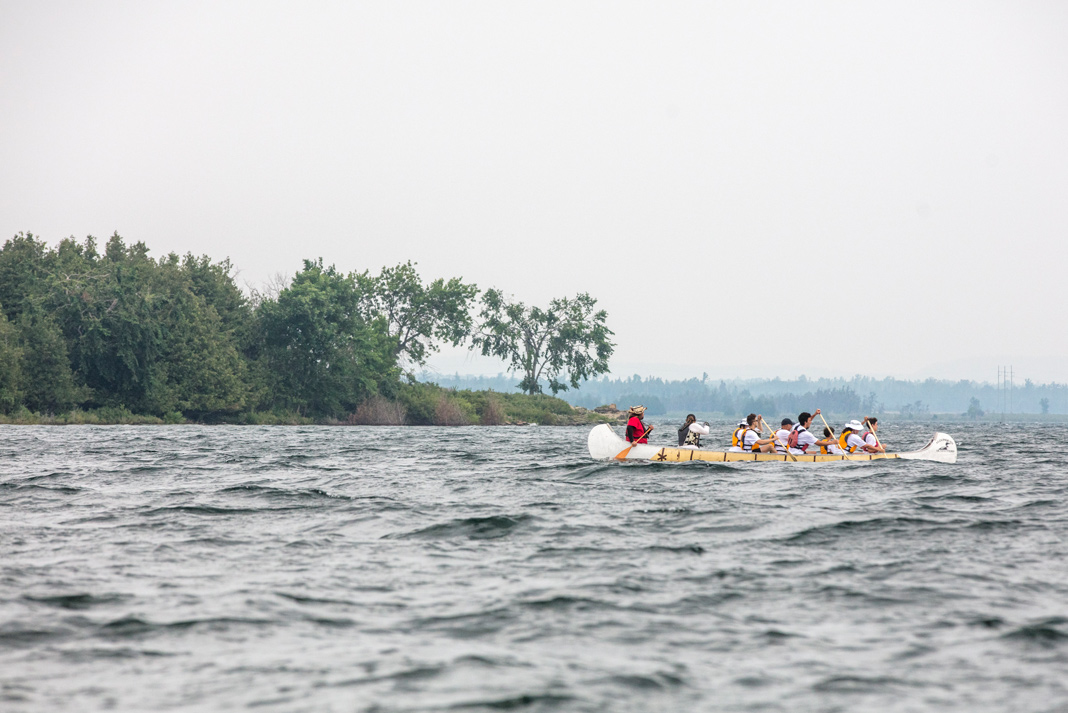 People paddling voyageur canoe