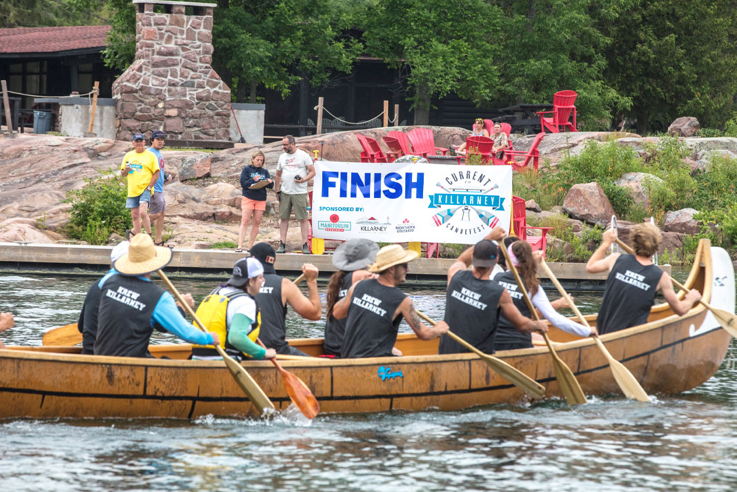 People paddling voyageur canoe