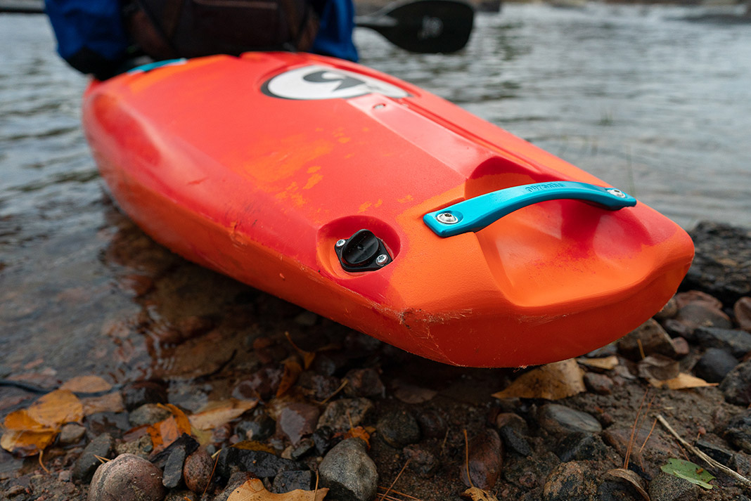 Person in red whitewater kayak