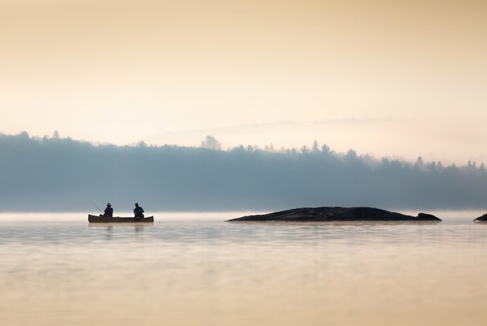 Two canoeists fish a secret honey hole