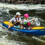 Review: Esquif Zephyr 2.0 XL A father and son paddle a blue Esquif Zephyr 2.0 XL whitewater canoe.