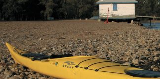 The Chatham 16 sea kayak from Necky Kayaks sits on a rocky beach