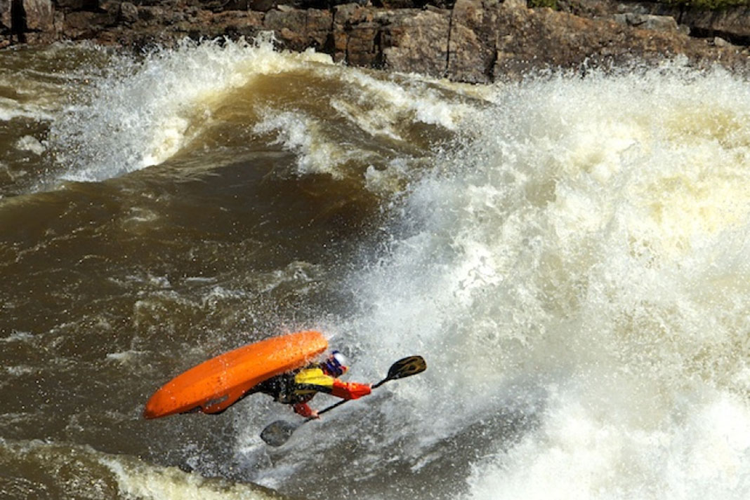 Person doing freestyle kayak maneuvers while kayaking the Ottawa River