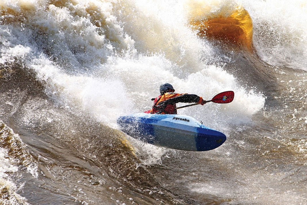 Man paddles the Pyranha JED kayak on the Ottawa River's Buseater rapid