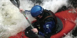 man paddles through whitewater rapids in a Dagger Juice kayak