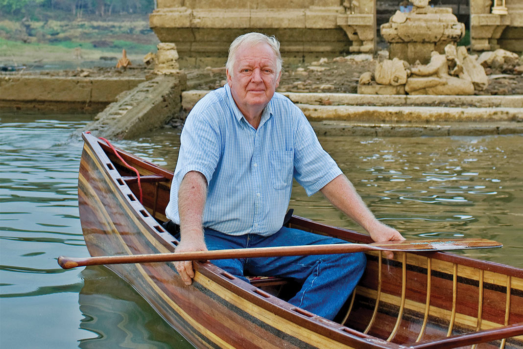 Man sitting in a wooden canoe