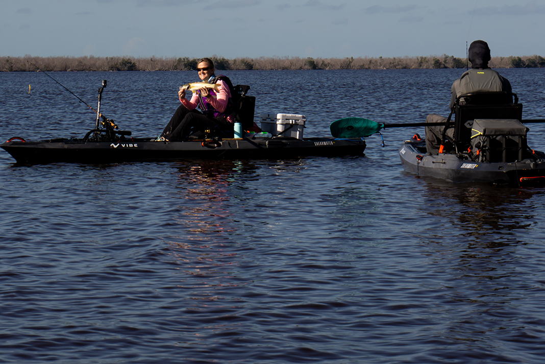 Two people on sit-on-top inshore fishing kayaks