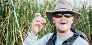 angler holds up a finesse rig for bass fishing