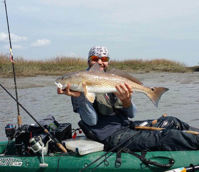 Scott Coughlin holds up a big red he caught on a super low tide. Photos: Scott Coughlin