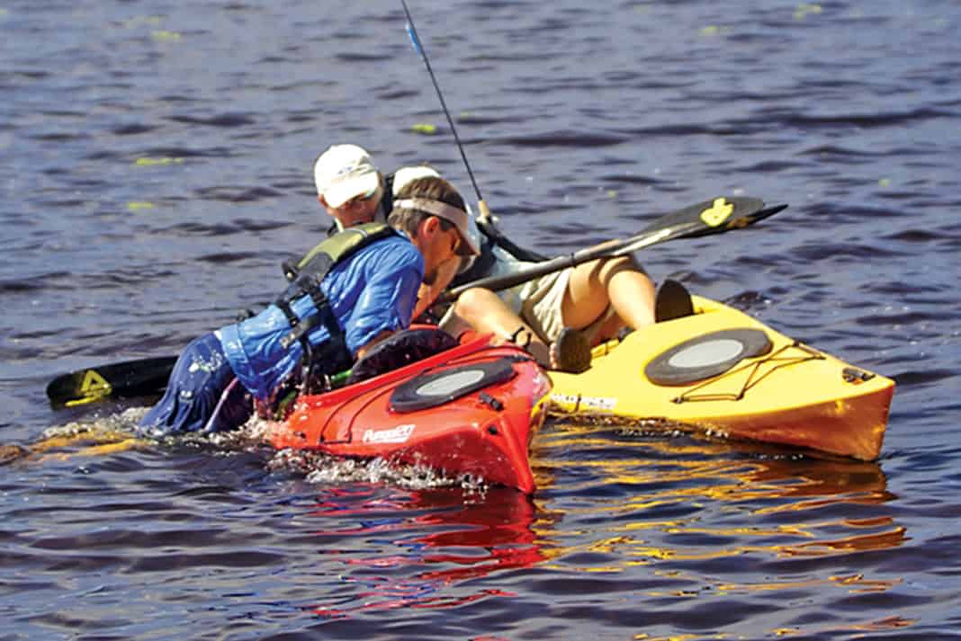 Kayak anglers practice doing a self-rescue on the water while fishing